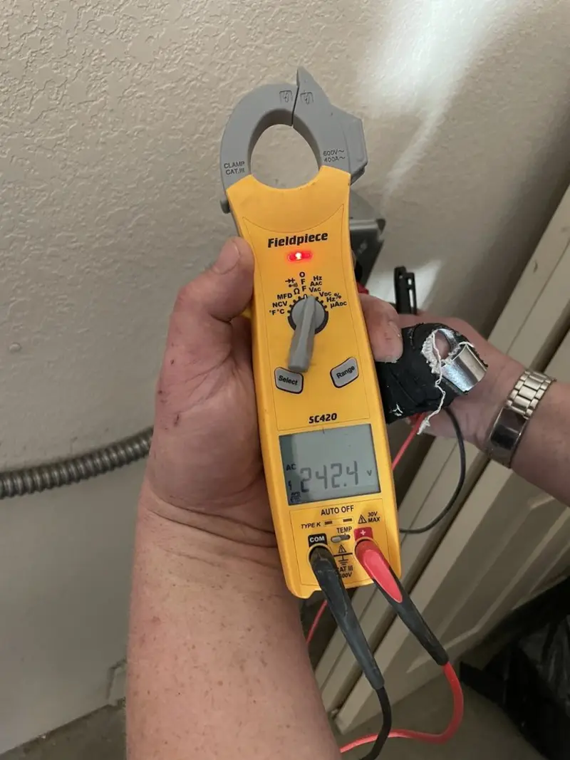 Voltage testing with clamp meter during Outlet Installation in Logansport